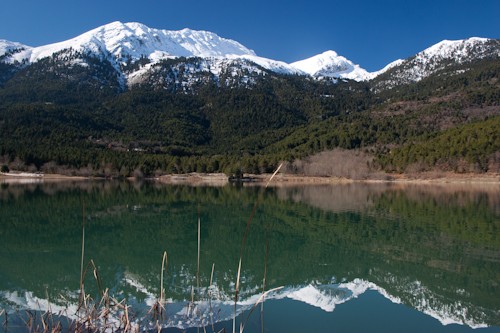 Doxa lake and mountain Helmos reflection on its calm water